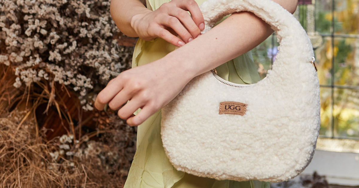 closer look at a white UGG bag worn in a formal event