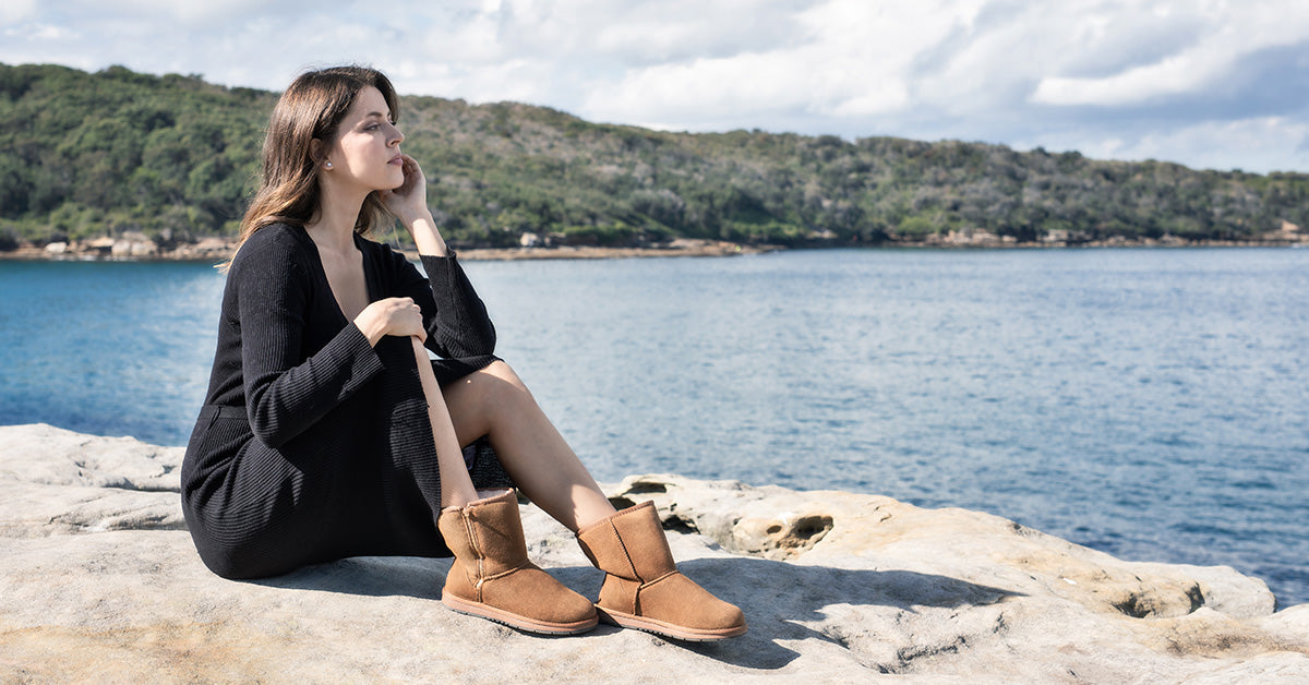 woman breaking in new UGGs by the shore