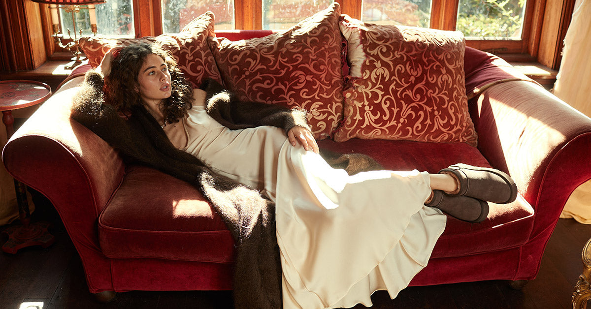 women relaxing on the couch while wearing UGG classic boots as a therapy