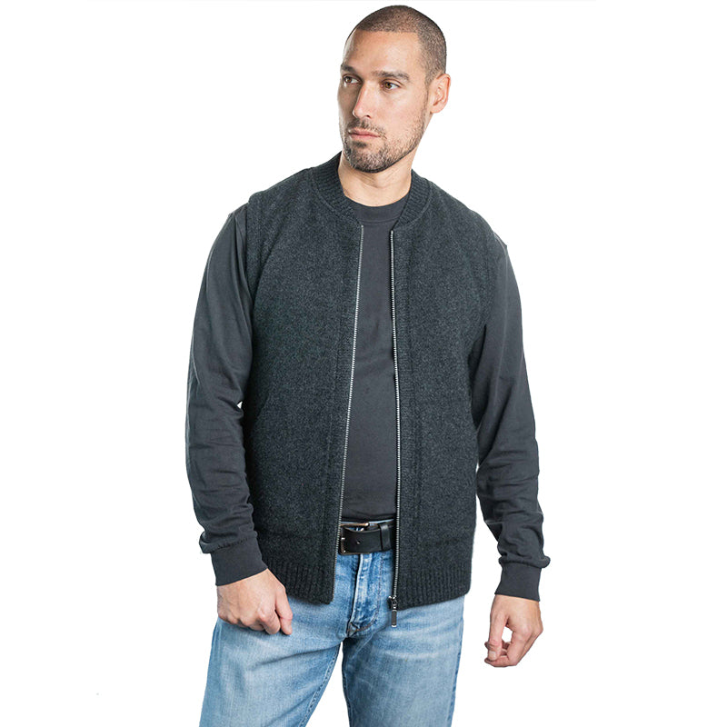 Man wearing a charcoal UGG knit zip vest layered over a long sleeve shirt, warm casual winter vest styled with denim for everyday wear in Australia