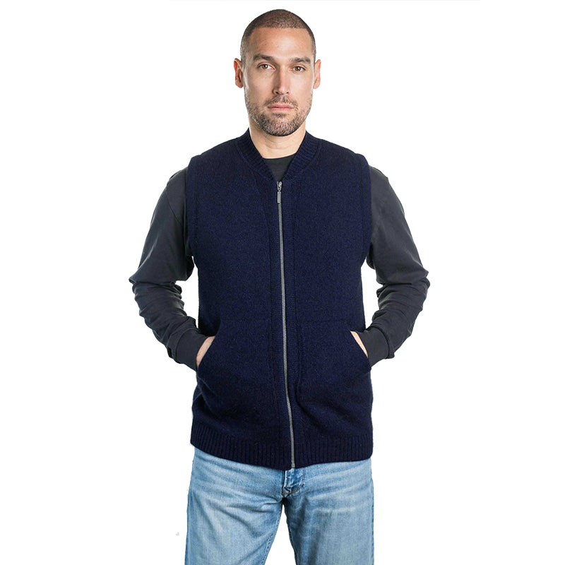 Man wearing a navy UGG knit zip vest layered over a long sleeve shirt, warm casual winter outfit styled with denim for everyday wear in Australia