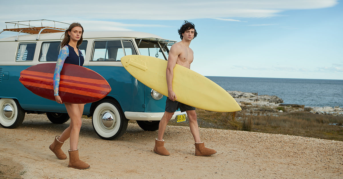 couple ready to surf on their honeymoon vacation-wearing UGG Australia before and after surf