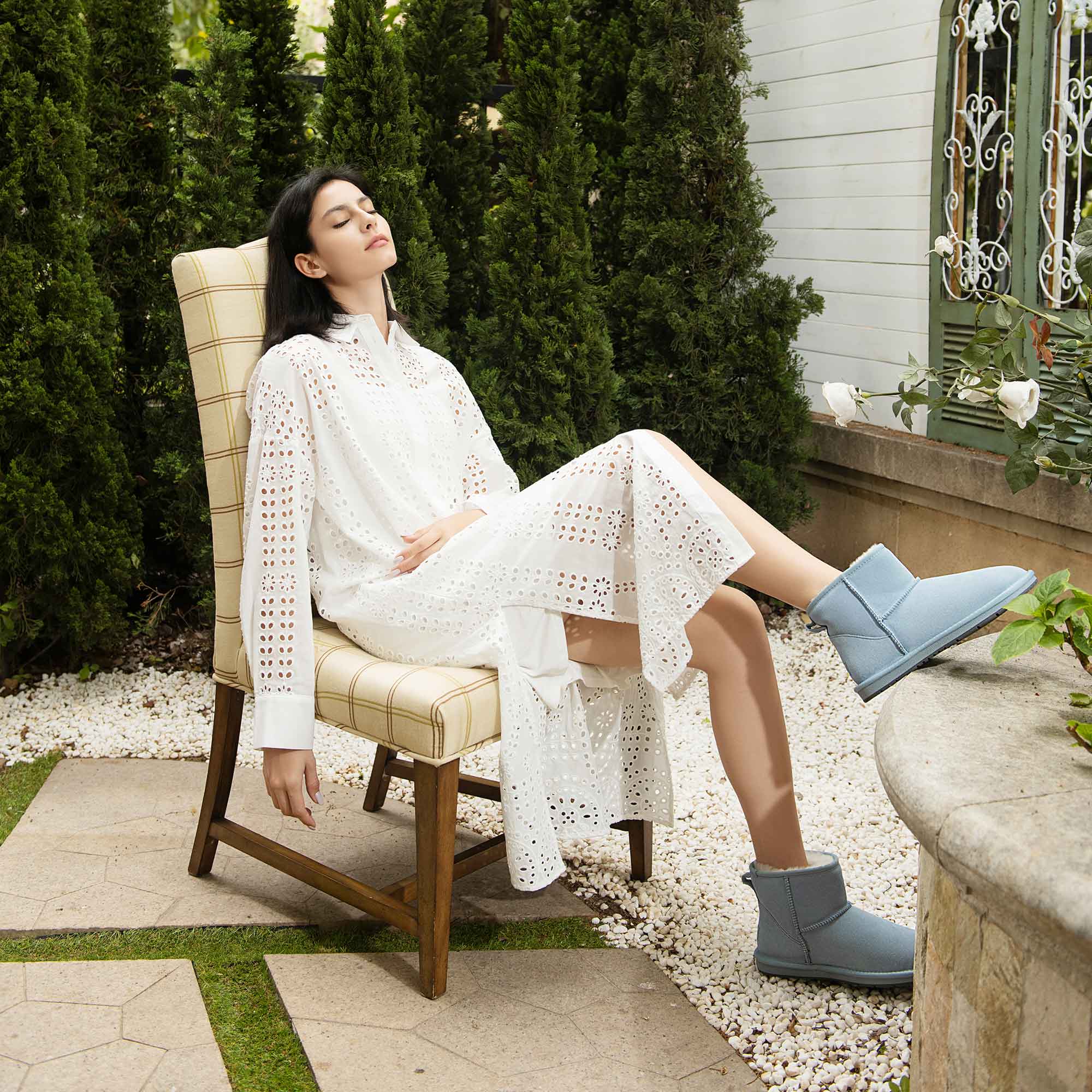 woman-relaxing-at-a-backyard-while-wearing-white-dress-and-blue-ugg-mini-classic-boots